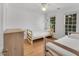 Bedroom featuring two twin beds, wood floors, ceiling fan and natural light from the windows at 2018 Waterton Ln, Apex, NC 27502