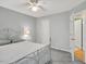 Bedroom with a metal frame bed, ceiling fan, carpet and a door leading to another room at 2018 Waterton Ln, Apex, NC 27502