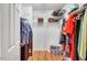 Walk-in closet with wood floors, wire shelving, hanging clothes, and ample storage space at 2018 Waterton Ln, Apex, NC 27502