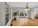 Open dining room featuring hardwood floors, natural light, and a decorative chandelier at 2018 Waterton Ln, Apex, NC 27502
