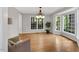 Bright dining room featuring hardwood floors, lots of light, and modern chandelier at 2018 Waterton Ln, Apex, NC 27502