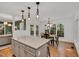 Bright dining room featuring hardwood floors, ample natural light, and pendant lighting, adjacent to island at 2018 Waterton Ln, Apex, NC 27502