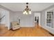Dining room featuring hardwood floors, lots of light, and decorative chandelier at 2018 Waterton Ln, Apex, NC 27502