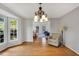 Dining room featuring hardwood floors, lots of light, and decorative chandelier at 2018 Waterton Ln, Apex, NC 27502