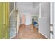Inviting foyer with hardwood floors, staircase, and view into the living area at 2018 Waterton Ln, Apex, NC 27502