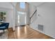 Bright, open foyer with hardwood floors and staircase leading to the upper level at 2018 Waterton Ln, Apex, NC 27502