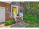 Welcoming front entrance with bright yellow door and neatly kept garden at 2018 Waterton Ln, Apex, NC 27502