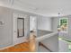 Upstairs hallway with hardwood floors, and natural light at 2018 Waterton Ln, Apex, NC 27502