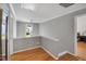 Open hallway with hardwood flooring and natural light streaming through the windows at 2018 Waterton Ln, Apex, NC 27502