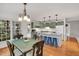 Open concept of kitchen, dining area, kitchen island with hardwood floors, and lots of windows at 2018 Waterton Ln, Apex, NC 27502