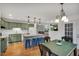 Open concept of kitchen, dining area, kitchen island with hardwood floors, and lots of windows at 2018 Waterton Ln, Apex, NC 27502