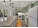 Updated kitchen featuring hardwood floors, a large island, and lots of natural light at 2018 Waterton Ln, Apex, NC 27502