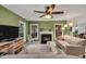 The living room features a fireplace, comfortable seating, television, and natural light, all in a cozy layout at 2018 Waterton Ln, Apex, NC 27502