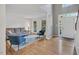 Sunlit living room featuring hardwood floors and an open floor plan with views to the foyer at 2018 Waterton Ln, Apex, NC 27502