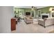 Cozy living room offers comfortable seating, natural light, desk area, and a view of the fireplace at 2018 Waterton Ln, Apex, NC 27502