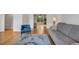 Open-concept living room featuring hardwood floors and a comfortable grey sofa at 2018 Waterton Ln, Apex, NC 27502