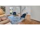 Bright living room featuring hardwood floors, and blue accent chairs at 2018 Waterton Ln, Apex, NC 27502