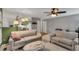 Open layout with gray walls, lots of natural light, living room set, and kitchen in the background at 2018 Waterton Ln, Apex, NC 27502