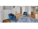 Open-concept living room featuring hardwood floors and blue accent chairs at 2018 Waterton Ln, Apex, NC 27502