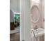 Stylish powder room featuring a pedestal sink and an oval mirror at 2018 Waterton Ln, Apex, NC 27502