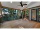 Spacious screened-in porch with ceiling fan, natural wood flooring, and access to the backyard at 2018 Waterton Ln, Apex, NC 27502
