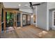 Wide screened porch featuring a ceiling fan, recessed lights, backyard access, and grey-colored siding at 2018 Waterton Ln, Apex, NC 27502