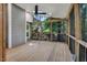 The relaxing screened porch features a ceiling fan and views of the natural surroundings at 2018 Waterton Ln, Apex, NC 27502