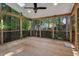 The bright screened porch has a ceiling fan, recessed lighting, and peaceful views of the surrounding trees at 2018 Waterton Ln, Apex, NC 27502