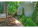 Landscaped side yard with stone pathway and lush green foliage around the perimeter of the home at 2018 Waterton Ln, Apex, NC 27502