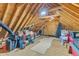 Unfinished attic space offering storage with exposed beams and wood flooring at 202 Reeder Branch Dr, Clayton, NC 27520