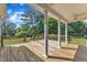 Back porch featuring wood flooring, white columns, ceiling fans, and railing at 202 Reeder Branch Dr, Clayton, NC 27520