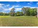 Expansive backyard featuring a lush lawn and mature trees, offering privacy and space for outdoor activities at 202 Reeder Branch Dr, Clayton, NC 27520