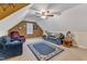 Bonus room with sloping ceilings features ample seating, storage, natural light, and a comfortable atmosphere at 202 Reeder Branch Dr, Clayton, NC 27520