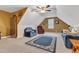 Attic conversion features built in shelving, carpet, multiple seating arrangements, and natural light at 202 Reeder Branch Dr, Clayton, NC 27520