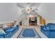 Spacious bonus room with sofas, carpet, tv setup, and ample seating perfect for recreation and media at 202 Reeder Branch Dr, Clayton, NC 27520