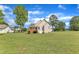 Exterior view of the home featuring a spacious backyard, deck, and neutral siding at 202 Reeder Branch Dr, Clayton, NC 27520