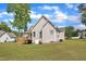 Exterior view of the home featuring a spacious backyard, deck, and neutral siding at 202 Reeder Branch Dr, Clayton, NC 27520