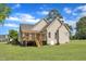 Exterior view of the home featuring a spacious backyard, deck, and neutral siding at 202 Reeder Branch Dr, Clayton, NC 27520