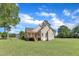 Exterior view of the home featuring a spacious backyard, deck, and neutral siding at 202 Reeder Branch Dr, Clayton, NC 27520