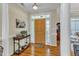 Welcoming foyer with hardwood floors, a decorative table, and natural light streaming in from the doorway at 202 Reeder Branch Dr, Clayton, NC 27520