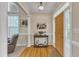 Bright foyer with wood floors, columns, and a charming console table styled with books and greenery at 202 Reeder Branch Dr, Clayton, NC 27520