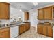 Kitchen with wood cabinets and a window to the living room at 202 Reeder Branch Dr, Clayton, NC 27520