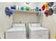 Laundry room featuring a shelf above the washer and dryer hookups, maximizing space for storage at 202 Reeder Branch Dr, Clayton, NC 27520