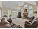 Spacious living room with fireplace, ceiling fan, and arched windows at 202 Reeder Branch Dr, Clayton, NC 27520