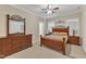 Relaxing main bedroom features wooden furniture, neutral walls, carpet flooring, and ample natural light at 202 Reeder Branch Dr, Clayton, NC 27520