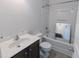 Bathroom with a vanity sink, toilet, and a shower-tub combination with white tiling at 204 Stockton Gorge Rd. Rd, Morrisville, NC 27560