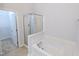 Bright bathroom featuring a soaking tub, separate glass shower, and an adjacent walk-in closet at 204 Stockton Gorge Rd. Rd, Morrisville, NC 27560