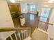 Interior view from the staircase shows an open concept kitchen, living room, and dining area at 204 Stockton Gorge Rd. Rd, Morrisville, NC 27560