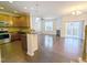 Open-concept living room and kitchen layout featuring hardwood floors, stainless steel appliances, and a fireplace at 204 Stockton Gorge Rd. Rd, Morrisville, NC 27560
