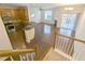Bright living space with hardwood floors, modern lighting, open kitchen, and stair access to upper level at 204 Stockton Gorge Rd. Rd, Morrisville, NC 27560
